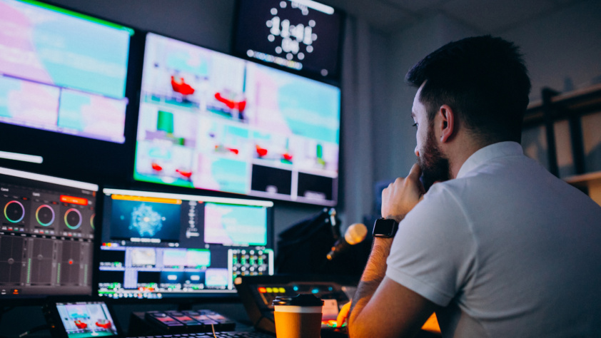 A man editing video with multi pc